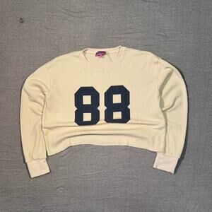 super cute cream henley cropped long sleeve tee with number logo graphic Edikted